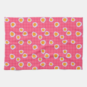 Fun spots on a coral pink chequered background tea towel