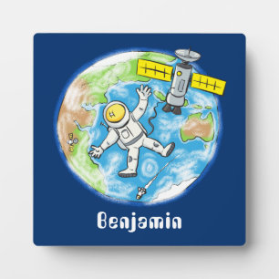 Funny astronaut in space and earth cartoon plaque