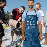Funny BBQ is a Man's Kitchen Apron<br><div class="desc">Experience laughter and style combine with our 'Funny Man Apron.' It features a visually appealing blue geometric pattern that will definitely catch eyes. But there's more to it than just a pretty face, the apron comes adorned with barbecue utensils and the unique, cheeky saying 'a bbq is a man's kitchen.'...</div>