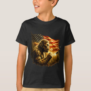 Funny bigfoot blowing dandelion with america flag  T-Shirt