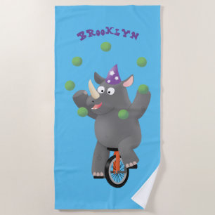 Funny cute rhino juggling on unicycle beach towel