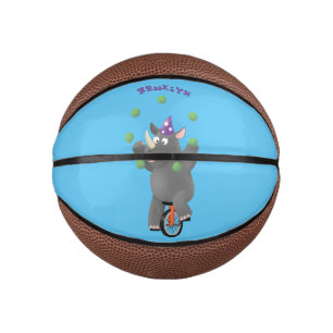 Funny cute rhino juggling on unicycle mini basketball