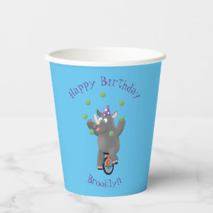 Funny cute rhino juggling on unicycle paper cups