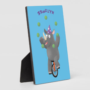Funny cute rhino juggling on unicycle plaque