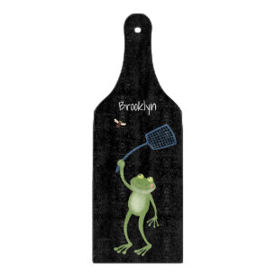 Funny green frog swatting fly cartoon  cutting board