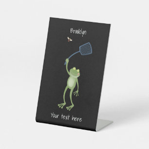Funny green frog swatting fly cartoon pedestal sign