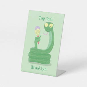 Funny green snake with maraca cartoon pedestal sign