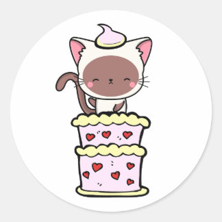 Funny white cat jumping out of a cake classic round sticker