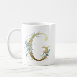 G golden initial with blue floral foliage coffee mug