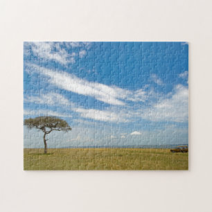 Game drive vehicle on open African plains Jigsaw Puzzle