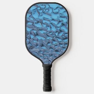 Gentle raindrops on blue glass pickleball paddle