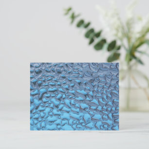 Gentle raindrops on blue glass postcard