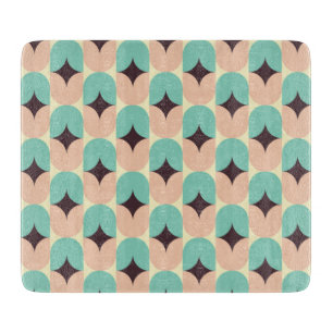 Geometric pattern of teal, beige, and black shapes cutting board