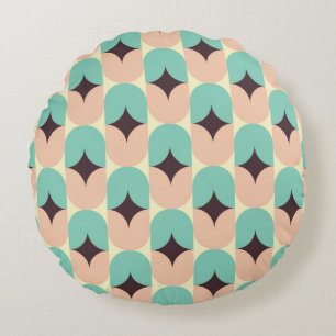 Geometric pattern of teal, beige, and black shapes round cushion