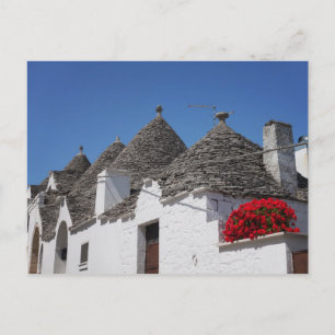 Geranium flowers and trulli houses in Alberobello Postcard