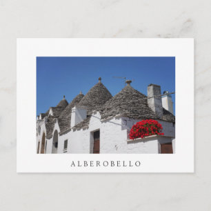 Geranium flowers and trulli houses in Alberobello Postcard