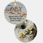 Ghost Crab OBX North Carolina Photographic Ceramic Tree Decoration<br><div class="desc">This photographic OBX beach ceramic ornament features an Atlantic Ghost Crab and his burrow in the beach sand. The Atlantic Ghost Crab can be found all along the Atlantic coast. As is, it is a travel souvenir of The Outer Banks North Carolina or the text may be customised with your...</div>