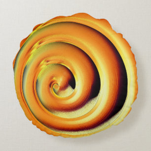 Giant shiny orange spiral over black round cushion