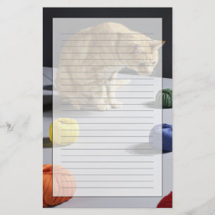 Ginger tabby cat sitting on table stationery
