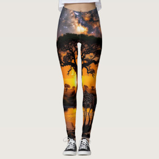 Giraffe drinking water in African Cosmic Sunset Leggings