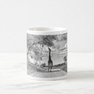Giraffe on the road coffee mug