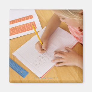 Girl doing homework magnet