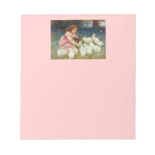 Girl feeding rabbits notepad