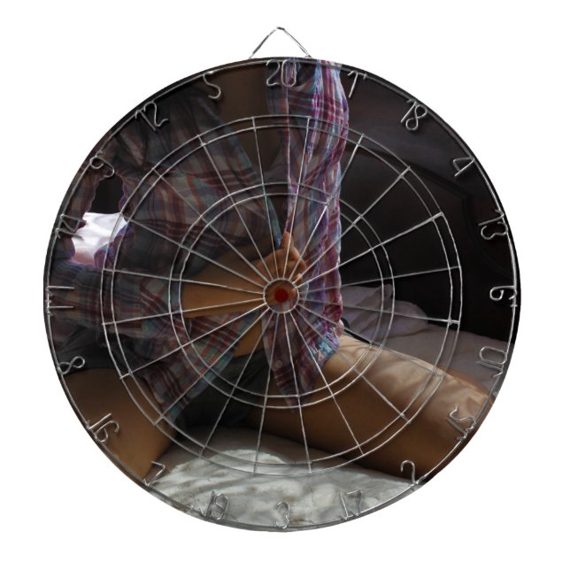 Girl in Flannel Shirt kneeling on a Bed Dartboard (Front)