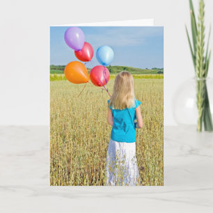 girl in wheat field with balloon bouquet card