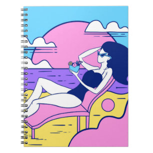 girl sunbathes on the beach with a cocktail in han notebook