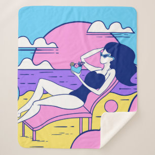 girl sunbathes on the beach with a cocktail in han sherpa blanket