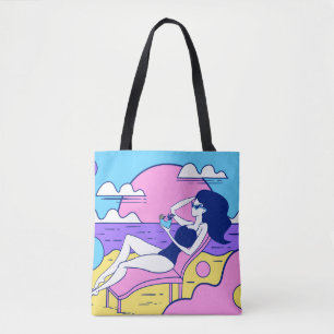 girl sunbathes on the beach with a cocktail in han tote bag