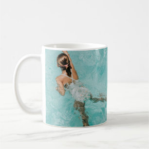 Girl wearing swimsuit and swims in swimming pool coffee mug