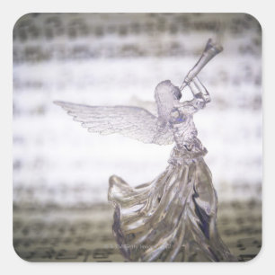 Glass angel playing trumpet and image of sheet square sticker