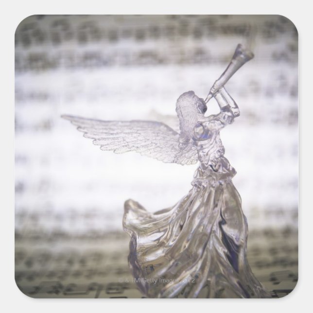 Glass angel playing trumpet and image of sheet square sticker (Front)