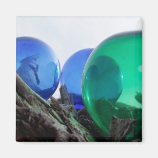 Glass floats on grey driftwood magnet