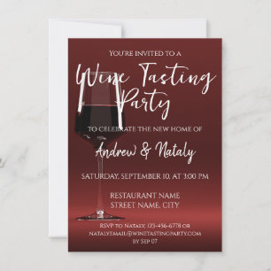 Glass of red wine on red invitation