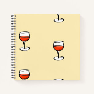 Glass of wine on orange notebook