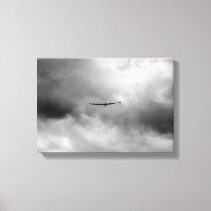 Glider flying in grey sky canvas print