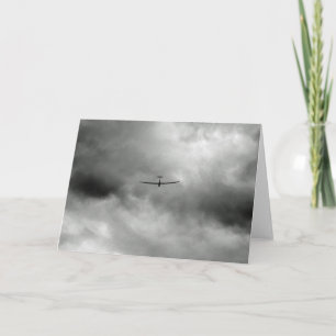 Glider flying in grey sky card