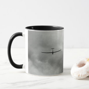 Glider flying in grey sky mug