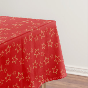 Glittering Golden Star Silhouettes on Vivid Red Tablecloth