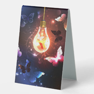 Glowing Light Bulb with Night Butterflies