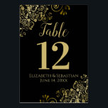 Gold and Black Elegant Frilly Wedding Table Number<br><div class="desc">These beautiful wedding table number cards feature a simple yet elegant design with gold script calligraphy on a black background with a frilly gold faux foil floral filigree in the corners. Perfect way to make your wedding reception beautiful and help your guests find the right table at the same time....</div>
