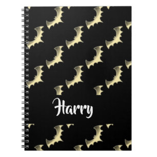 Gold bats on black notebook