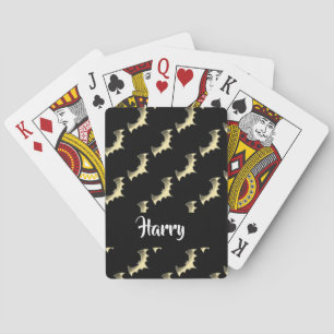 Gold bats on black playing cards