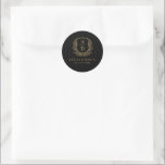 Gold Black Crest Modern Monogram Wedding  Classic Round Sticker<br><div class="desc">Add a sophisticated touch to your wedding with the Gold Black Crest Modern Monogram Wedding Classic Round Sticker. Featuring a striking black background, a luxurious gold crest design, and a personalised monogram, this sticker is perfect for enhancing your wedding invitations, favours, or stationery. Its elegant contrast and modern design make...</div>