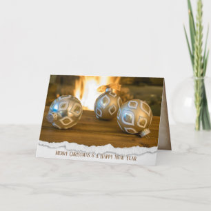 gold Christmas ornaments by fireplace Holiday Card