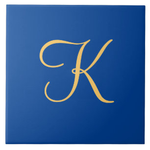 Gold-coloured initial K on dark blue background Tile