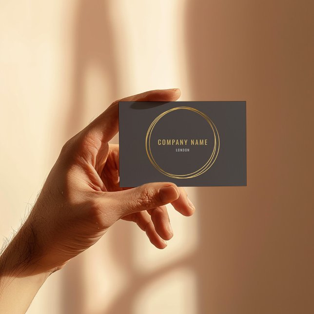 Gold effect, gold rings, grey background bold text business card (Sleek dark grey business card with gold foil circle and modern minimalist text)